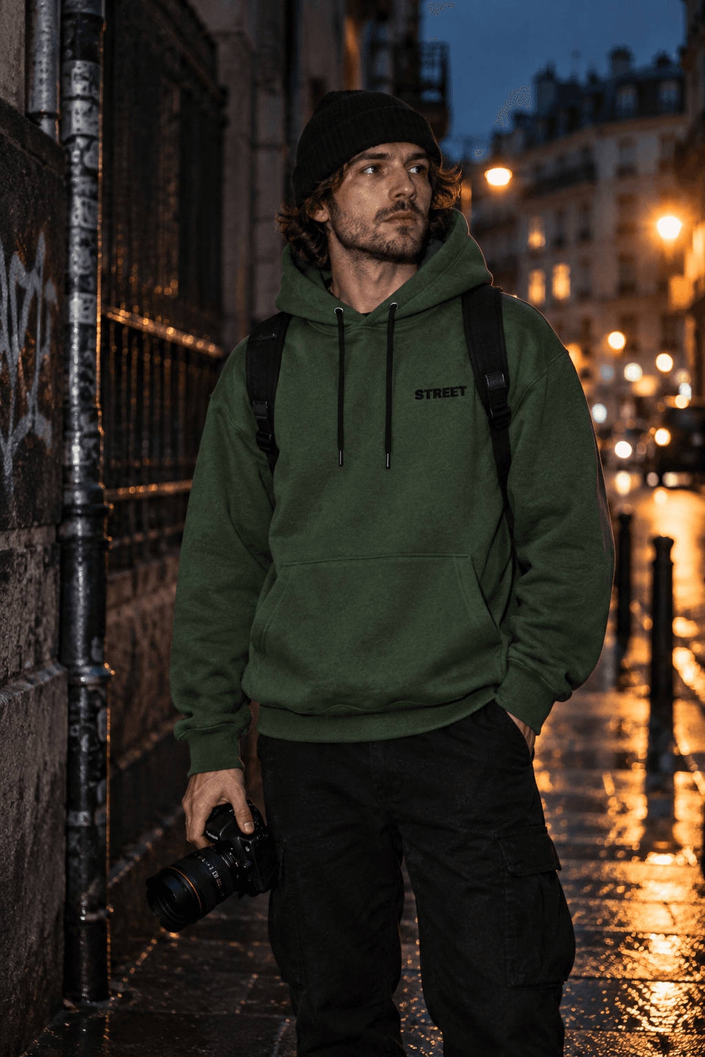 Street photographer wearing the green STREET hoodie at night