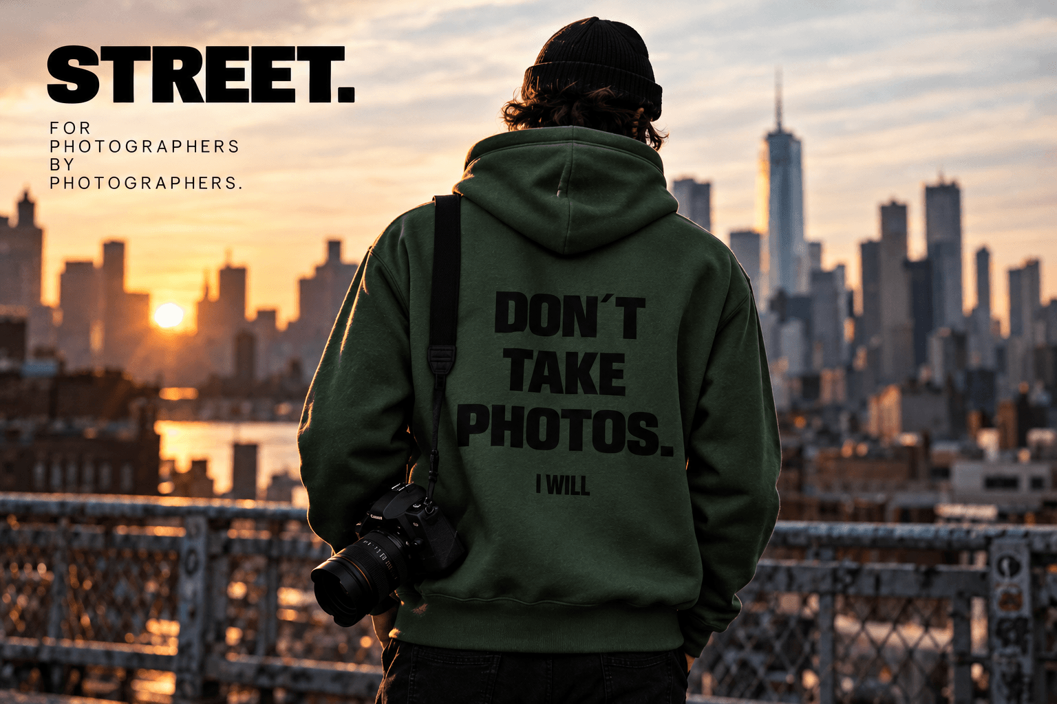 Photographer wearing the STREET hoodie on a rooftop at sunset